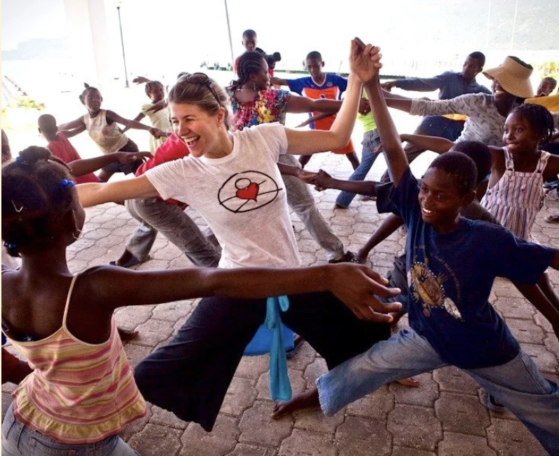 Lisa dancing and playing with Haitian children