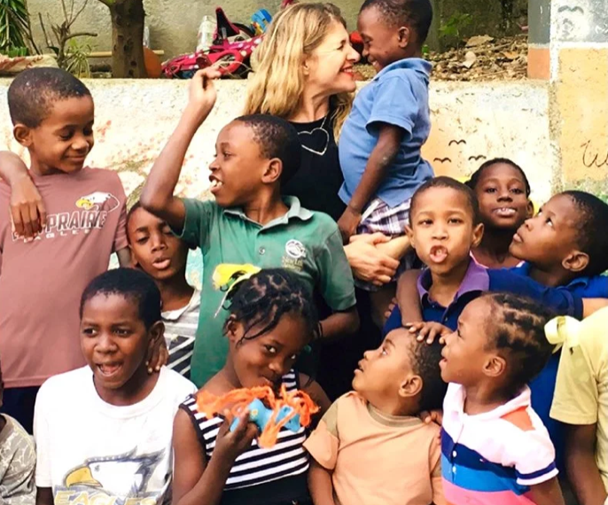 Lisa laughing with children in Haiti