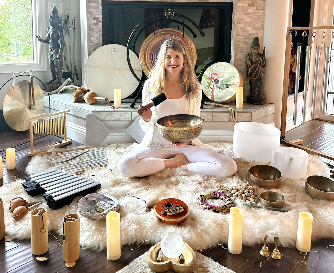 Lisa with hand drum and orchids by the fireplace